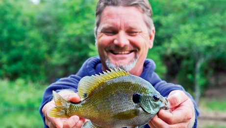 Shane Carter smiles with his bluegill catch