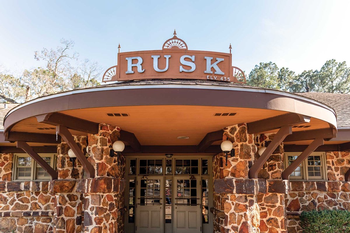 Stone building with a rusk sign atop an awning.