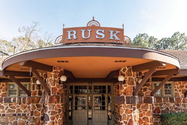 Stone building with a rusk sign atop an awning.