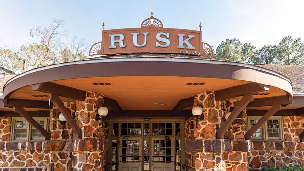 Stone building with a rusk sign atop an awning.
