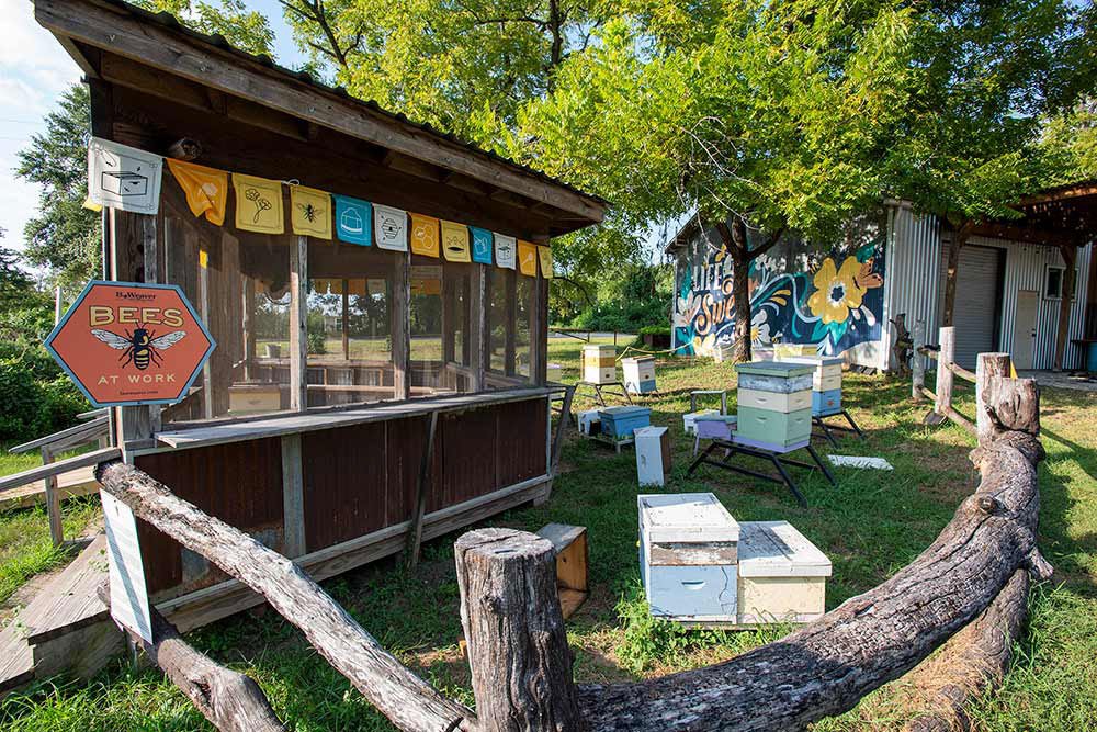 Colorful banners hand from the exterior of a booth at the Beeweaver Honey Farm in Navasota