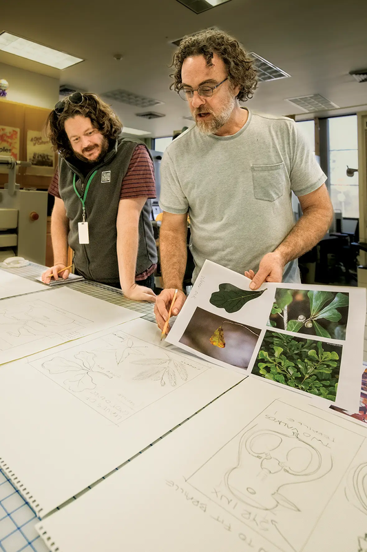Two State Park Team members creating sketches for replicas to place in exhibits