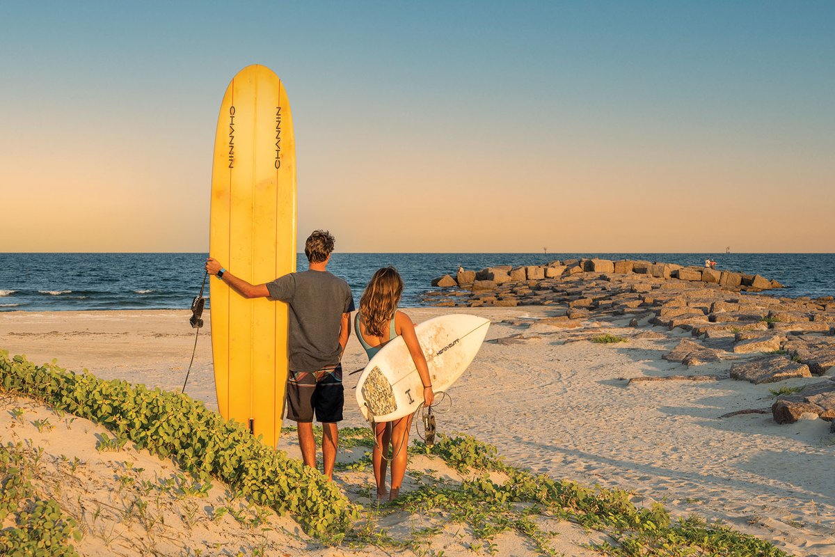 Two surfers on a beach.