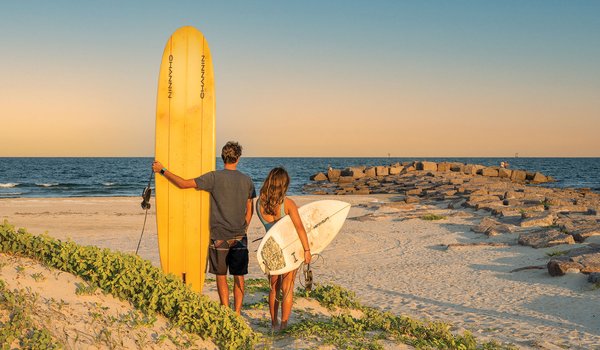 Two surfers on a beach.