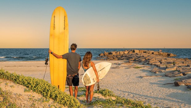 Two surfers on a beach.