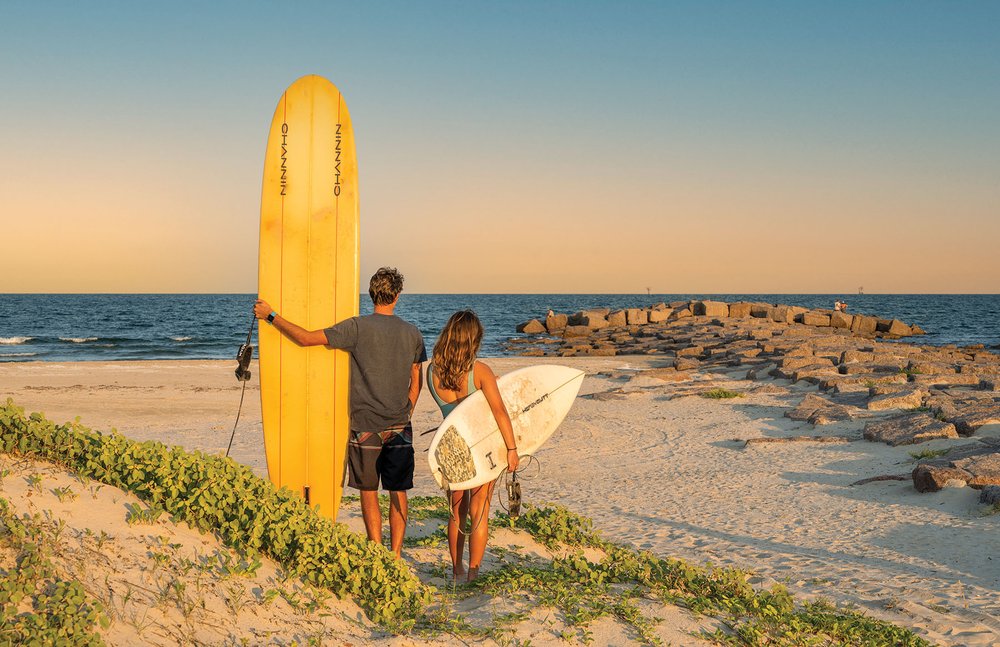 Two surfers on a beach.