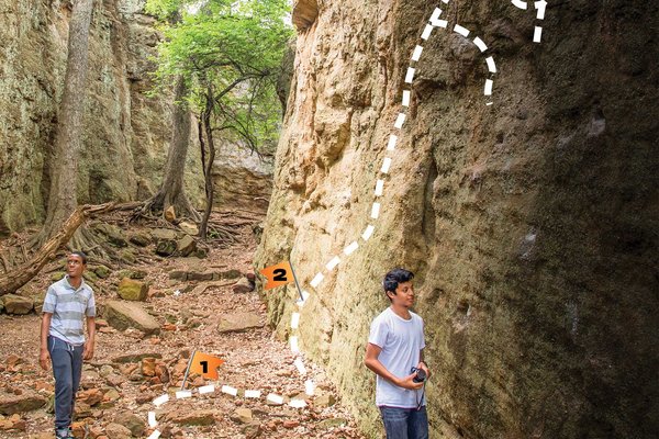 Two young adults walking a trail. A map of the trail is superimposed on the photo.
