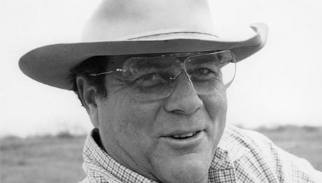 Walter Fondren III in a cowboy hat, glasses and flannel shirt