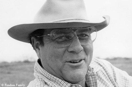 Walter Fondren III in a cowboy hat, glasses and flannel shirt