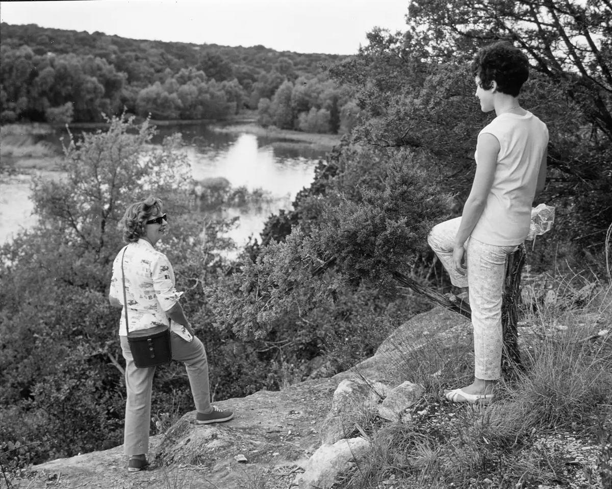 Women at Meridian State Park stand on Bee Ledge lookout point facing the park’s 72-acre lake