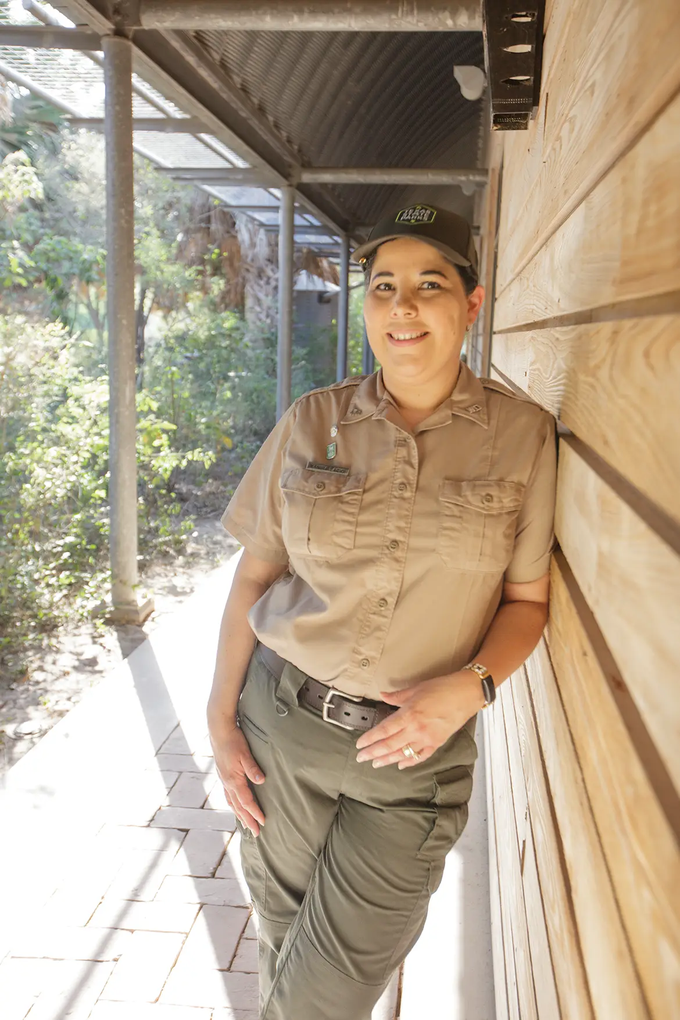 Yanira Lacio the office manager is leaning against an outside wall at Bentsen-Rio Grande Valley State Park