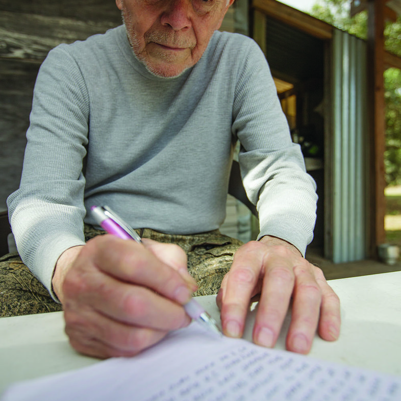 Don Spencer records the days events in the family hunting journal
