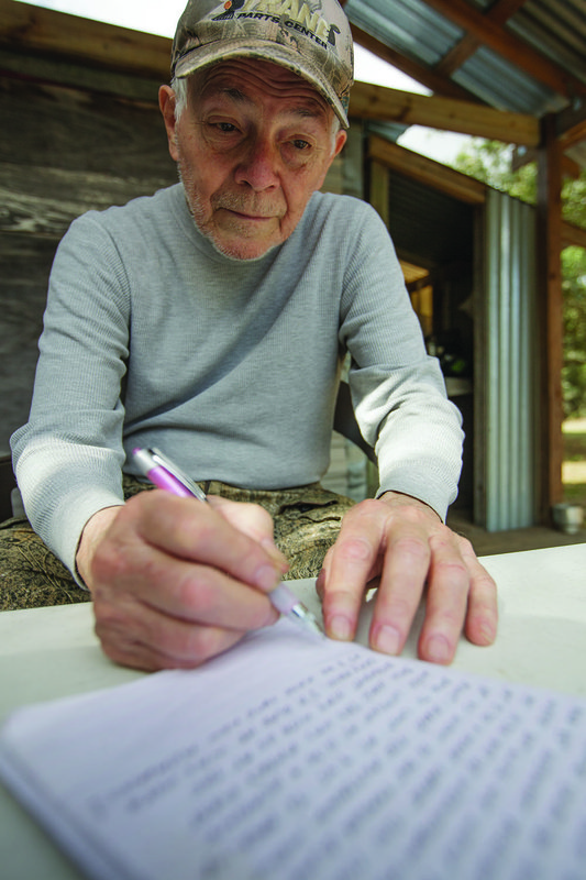 Don Spencer records the days events in the family hunting journal