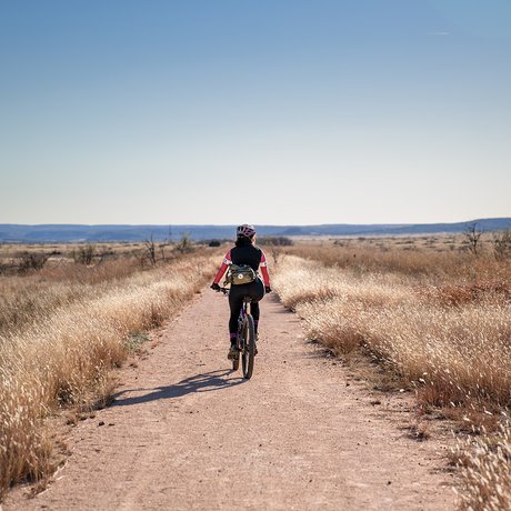 A biker rides on dirt railsway