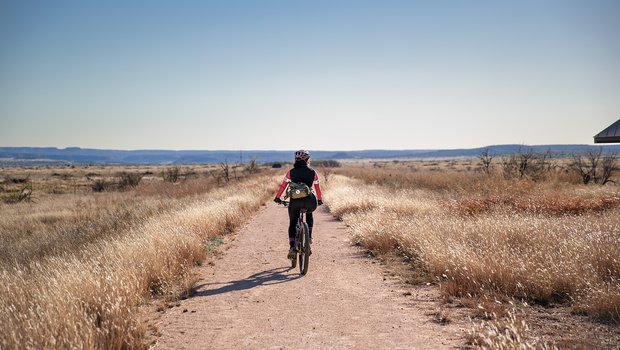 A biker rides on dirt railsway