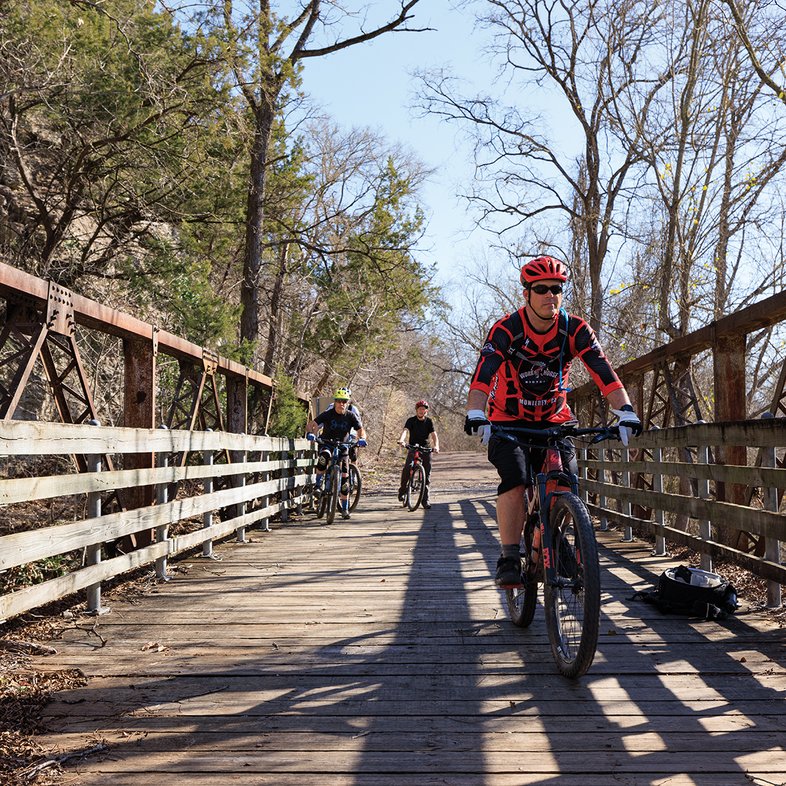 Bikers crossing a wood bridge
