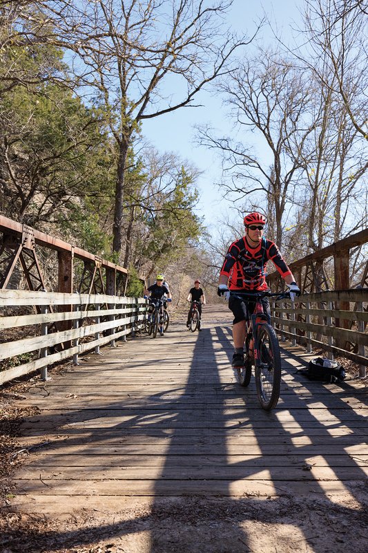 Bikers crossing a wood bridge