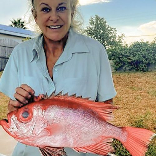 Cathy Johnson holds a short bigeye fish