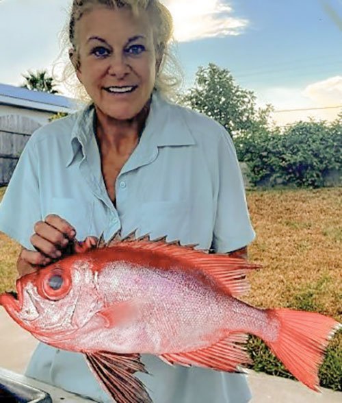 Cathy Johnson holds a short bigeye fish