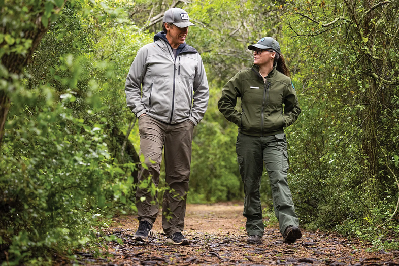 couple walking down a wooded trail