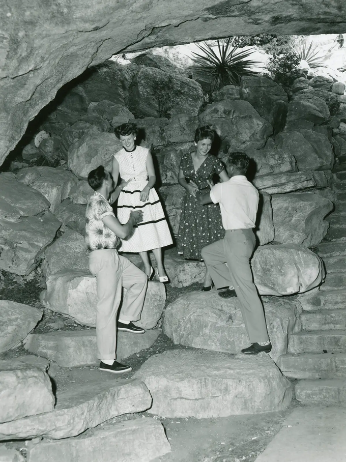 couples posing on the rocks at Longhorn Cavern  in the 1950s.