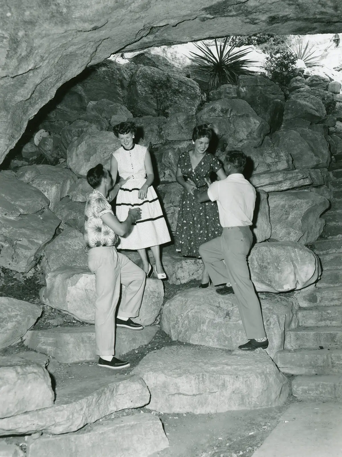 couples posing on the rocks at Longhorn Cavern  in the 1950s.