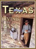 June 2004 Cover - Man standing in a door of a wood cabin wearing clothes from the past - title: Living the Past