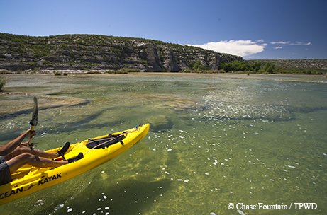 devils river state natural area with person paddling in a yellow kayak