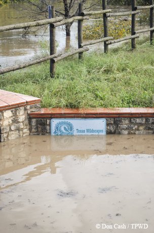 high water mckinney state park with water coming up the middle of the state park sign.