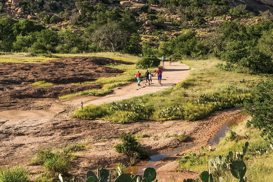 hikers hiking up to enchanted rock