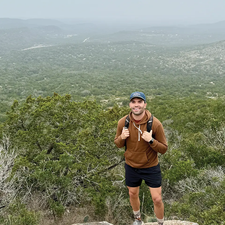 John Sorsby Standing on a rock in the hill country.