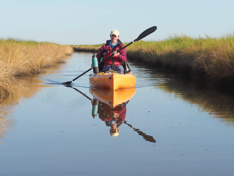 kayaker in a grass channel at Sear Rim State Park