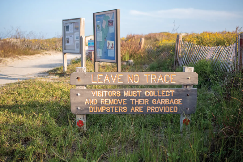 wooden 'leave no trace' sign at park entrance