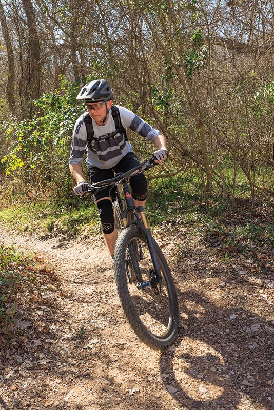 A person mountain biking down a trail
