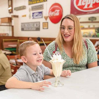 A mom and son enjoy a sundae
