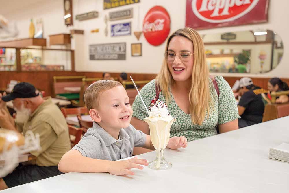 A mom and son enjoy a sundae