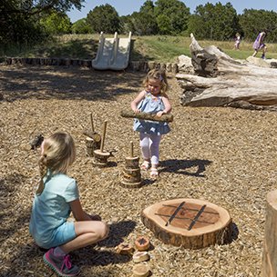 mother neff anarchy area with children playing with natural items