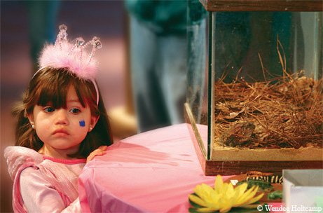princess looking at Houston toads in a tank during a 'head start' program