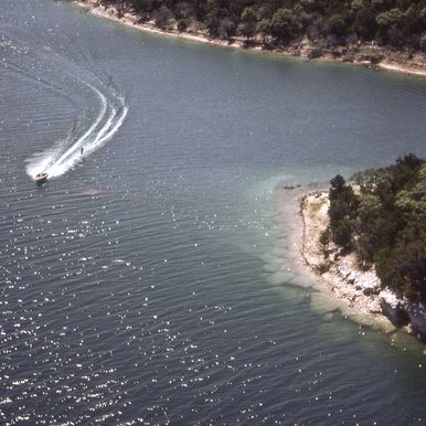 Lake with shoreline and boat visible