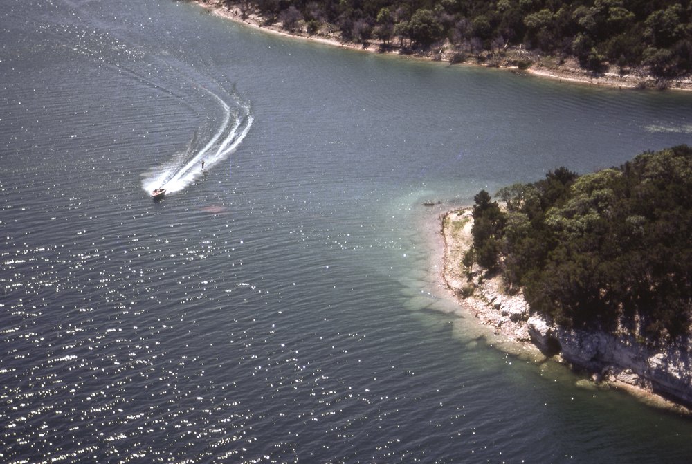 Lake with shoreline and boat visible