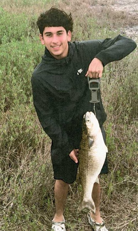 Thomas Valadez holds his striped mullet