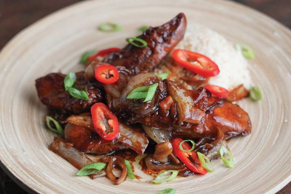 Turkey adobo on a white plate.