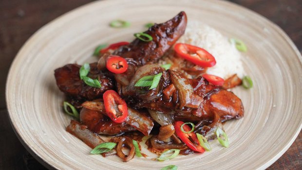 Turkey adobo on a white plate.