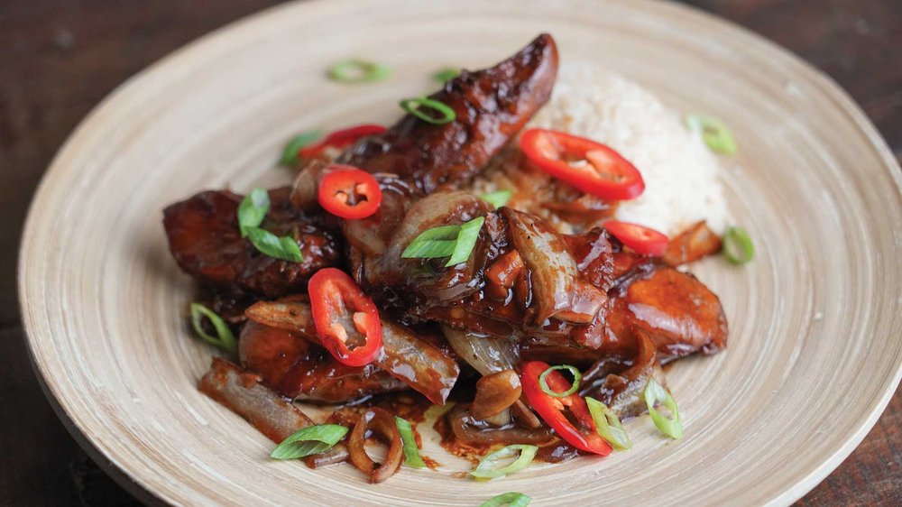Turkey adobo on a white plate.
