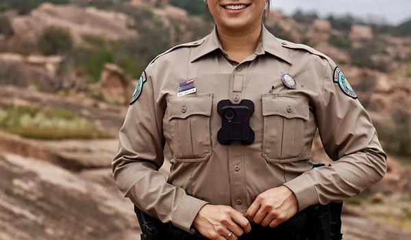 game warden Wei-Wei Lin standing at the base of a rocky hill
