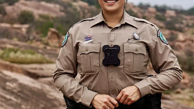 game warden Wei-Wei Lin standing at the base of a rocky hill