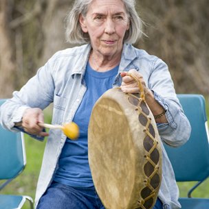 woman drumming at a park