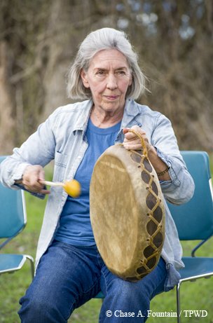 woman drumming at a park