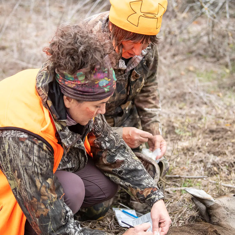 women tagging a deer