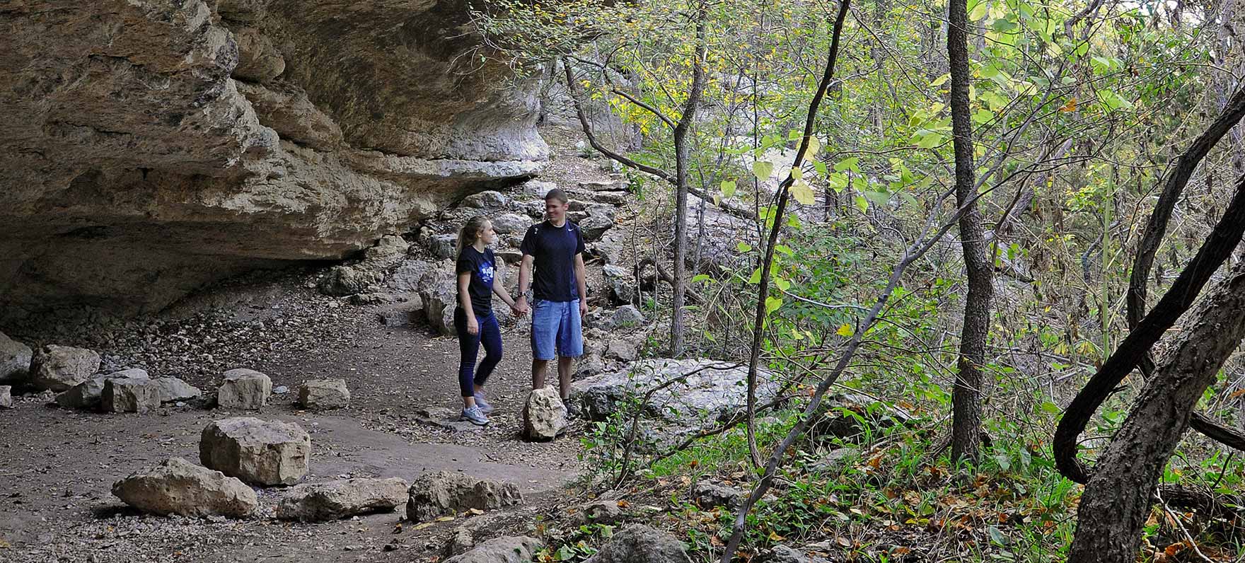 couple hiking in cave at Mother Neff state park